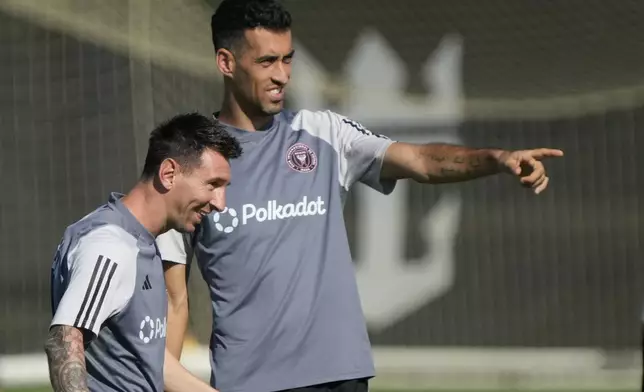 Inter Miami forward Lionel Messi, foreground, and midfielder Sergio Busquets chat as they work out at the MLS soccer team's training facility, Friday, Sept. 13, 2024, in Fort Lauderdale, Fla. (AP Photo/Wilfredo Lee)