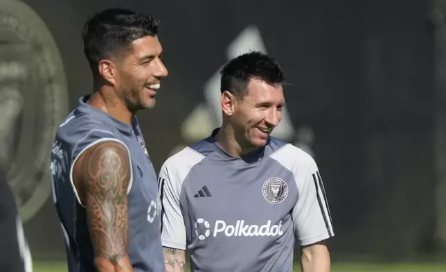 Inter Miami forwards Lionel Messi, right, and Luis Suarez, share a laugh as the work out at the MLS soccer team's training facility, Friday, Sept. 13, 2024, in Fort Lauderdale, Fla. (AP Photo/Wilfredo Lee)