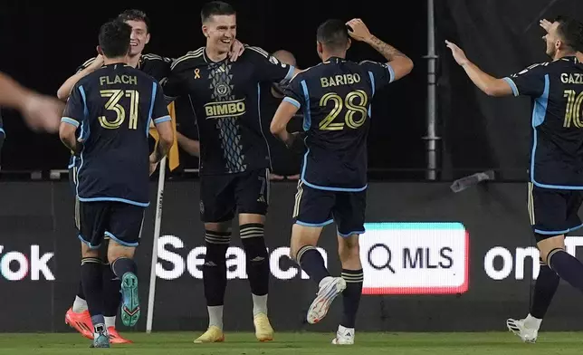 Teammates celebrate a goal by Philadelphia Union forward Mikael Uhre (7) during the first half of an MLS soccer match against the Inter Miami, Saturday, Sept. 14, 2024, in Fort Lauderdale, Fla. (AP Photo/Marta Lavandier)