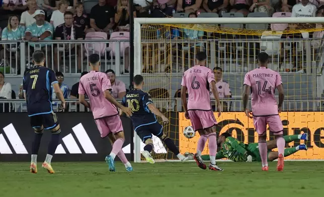 Inter Miami goalkeeper Drake Callender (1) is unable to catch a goal by Philadelphia Union forward Mikael Uhre (7) during the first half of an MLS soccer match, Saturday, Sept. 14, 2024, in Fort Lauderdale, Fla. (AP Photo/Marta Lavandier)