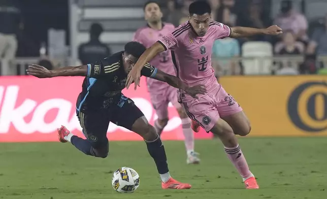 Philadelphia Union defender Nathan Harriel (26) and Inter Miami midfielder Diego GÛmez (20) go after the ball during the first half of an MLS soccer match, Saturday, Sept. 14, 2024, in Fort Lauderdale, Fla. (AP Photo/Marta Lavandier)