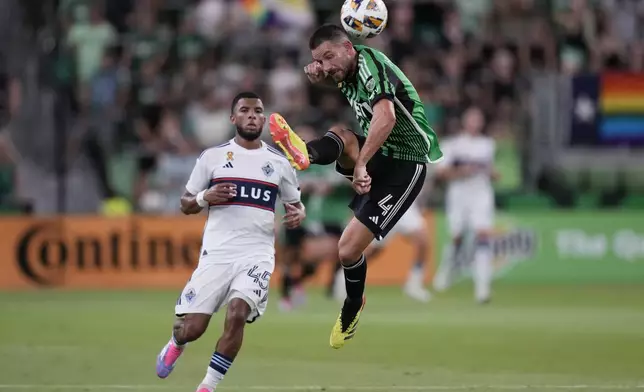 Austin FC defender Brendan Hines-Ike (4) moves the ball pass Vancouver Whitecaps midfielder Pedro Vite (45) during the second half of an MLS soccer match in Austin, Texas, Saturday, Aug. 31, 2024. (AP Photo/Eric Gay)