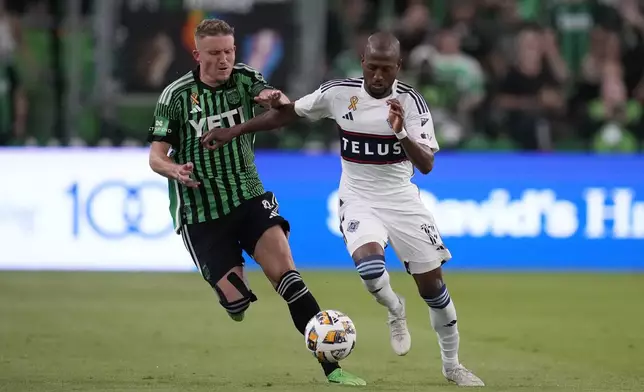 Austin FC midfielder Alexander Ring, left, and Vancouver Whitecaps midfielder Fafà Picault, right, battle for control of the ball during the second half of an MLS soccer match in Austin, Texas, Saturday, Aug. 31, 2024. (AP Photo/Eric Gay)