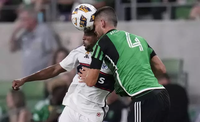 Vancouver Whitecaps midfielder Fafa Picault (11) and Austin FC defender Brendan Hines-Ike (4) coiled as they leap to head the ball during the second half of an MLS soccer match in Austin, Texas, Saturday, Aug. 31, 2024. (AP Photo/Eric Gay)