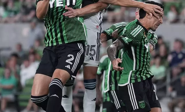 Austin FC defender Matt Hedges (2) and Vancouver Whitecaps defender Bjørn Inge Utvik (15) jump for a pass during the second half of an MLS soccer match in Austin, Texas, Saturday, Aug. 31, 2024. (AP Photo/Eric Gay)