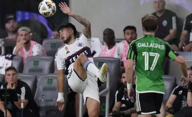 Vancouver Whitecaps midfielder Ryan Raposo, left, fields the ball in front of Austin FC forward Jon Gallagher (17) during the first half of an MLS soccer match in Austin, Texas, Saturday, Aug. 31, 2024. (AP Photo/Eric Gay)