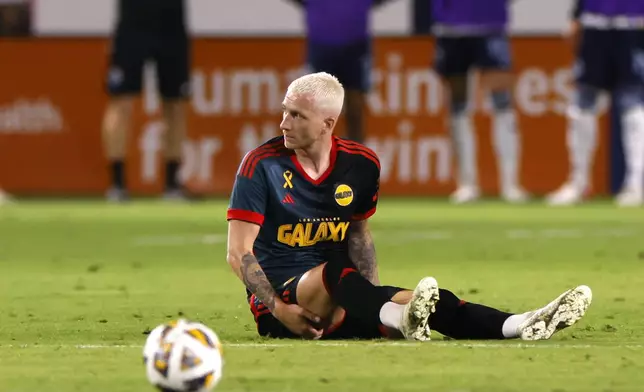 Los Angeles Galaxy's Marco Reus reacts while sitting on the field during the second half of an MLS soccer match against the Vancouver Whitecaps, Saturday, Sept. 21, 2024, in Carson, Calif. (AP Photo/Etienne Laurent)