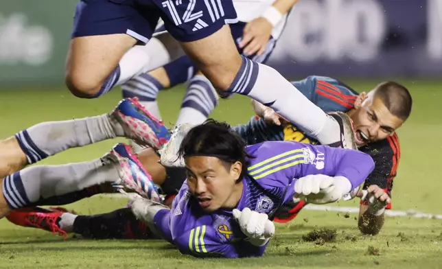 Los Angeles Galaxy's Dejan Joveljic, right, scores against Vancouver Whitecaps' Yohei Takaoka (1) during the second half of an MLS soccer match Saturday, Sept. 21, 2024, in Carson, Calif. (AP Photo/Etienne Laurent)