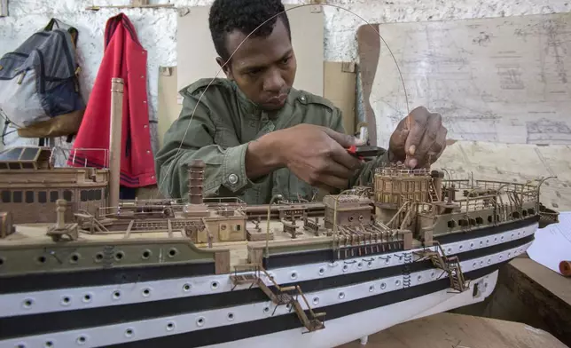 A Malagasy man builds a model ship at the Le Village model ship making company in Antananarivo, Madagascar, Wednesday, Sept. 11, 2024. (AP Photo/Alexander Joe)