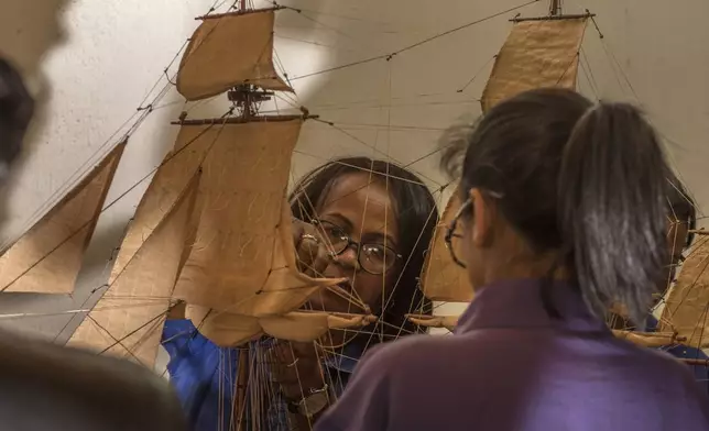 Malagasy women build a model ship at the Le Village model ship making company in Antananarivo, Madagascar, Wednesday, Sept. 11, 2024. (AP Photo/Alexander Joe)