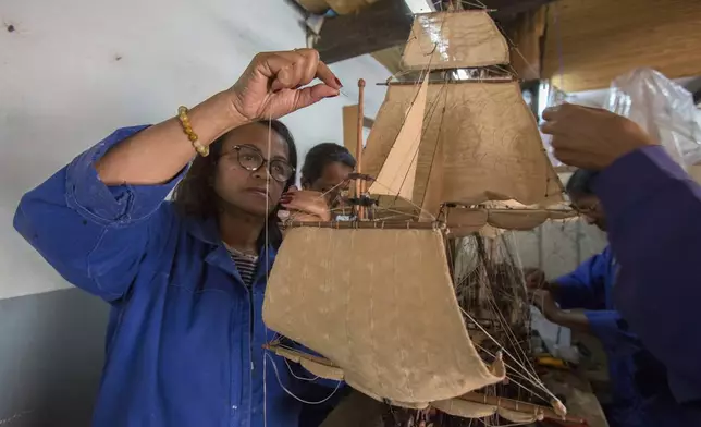 Malagasy women build a model ship at the Le Village model ship making company in Antananarivo, Madagascar, Wednesday, Sept. 11, 2024. (AP Photo/Alexander Joe)