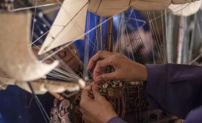 Malagasy women build a model ship at the Le Village model ship making company in Antananarivo, Madagascar, Wednesday, Sept. 11, 2024. (AP Photo/Alexander Joe)