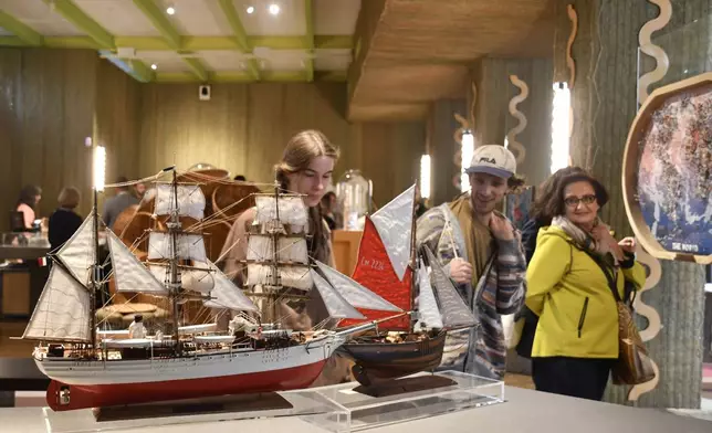 Visitors attend an exhibition of model ships made by the Madagascar company Le Village and on display at the Homo Faber 2024 show in Venice, Italy, Friday, Sept. 13, 2024.(AP Photo/Luigi Costantini)