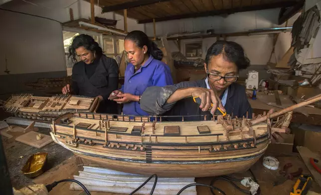 Malagasy women build a model ship at the Le Village model ship making company in Antananarivo, Madagascar, Wednesday, Sept. 11, 2024. (AP Photo/Alexander Joe)