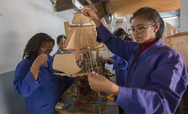 Malagasy women build a model ship at the Le Village model ship making company in Antananarivo, Madagascar, Wednesday, Sept. 11, 2024. (AP Photo/Alexander Joe)