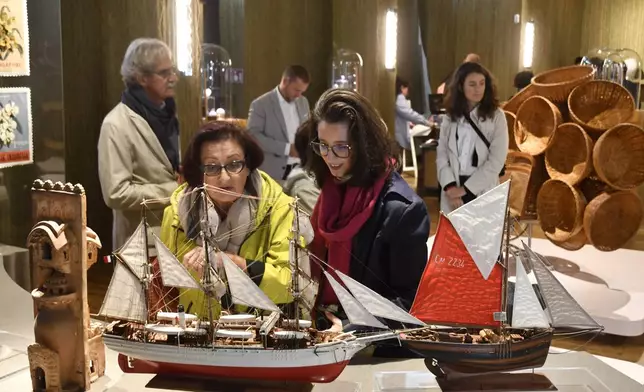 Visitors attend an exhibition of model ships made by the Madagascar company Le Village and on display at the Homo Faber 2024 show in Venice, Italy, Friday, Sept. 13, 2024.(AP Photo/Luigi Costantini)