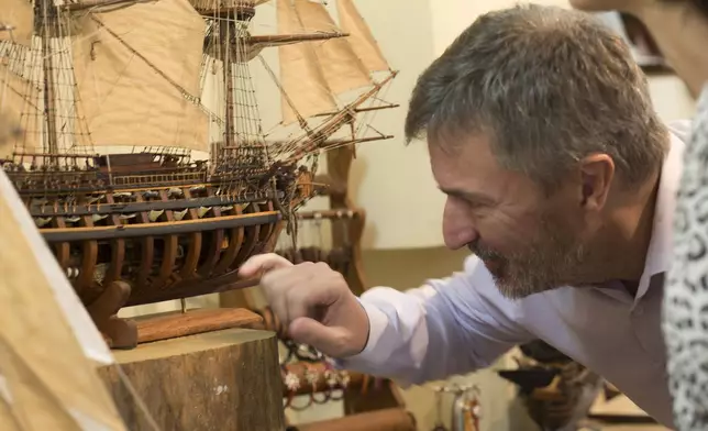 Owner, Grégory Postel inspects a model ship at the Le Village model ship making company in Antananarivo, Madagascar, Wednesday, Sept. 11, 2024. (AP Photo/Alexander Joe)