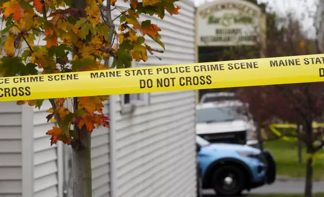 FILE - Crime scene tape surrounds Schemengees Bar &amp; Grille, Sunday, Oct. 29, 2023, in Lewiston, Maine. Two law enforcement officers were thrust into the media spotlight after Maine's deadliest shooting. Now they're facing each other in an election (AP Photo/Matt Rourke, File)