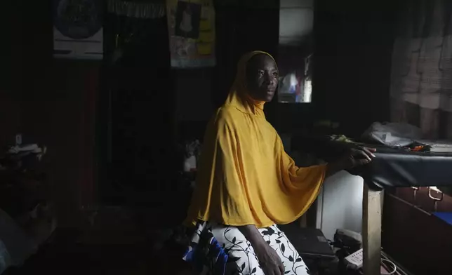 Idowu Bello, 56, poses for a photograph inside her house in Ibadan, Nigeria, Friday, Sept. 13, 2024. (AP Photo/Sunday Alamba)