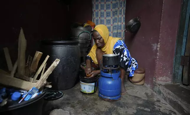 Idowu Bello, 56, prepares a meal in her kitchen in Ibadan, Nigeria, Friday, Sept. 13, 2024. (AP Photo/Sunday Alamba)