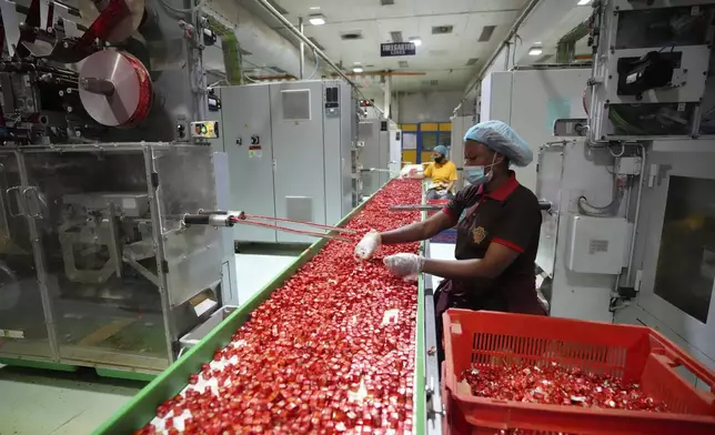 Workers package bouillon cubes at the Sweet Nutrition factory in Ota, Nigeria, Thursday, Sept. 12, 2024. (AP Photo/Sunday Alamba)