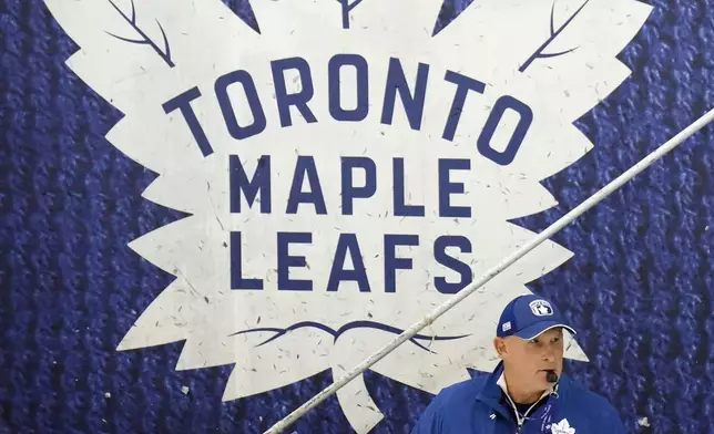 Toronto Maple Leafs new head coach Craig Berube runs his team's drills during NHL training camp in Toronto, Thursday, Sept. 19, 2024. (Nathan Denette/The Canadian Press via AP)