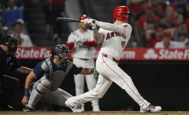 Los Angeles Angels' Mickey Moniak hits a home run during the seventh inning of a baseball game against the Seattle Mariners in Anaheim, Calif., Saturday, Aug. 31, 2024. Anthony Rendon also scored. (AP Photo/Ashley Landis)