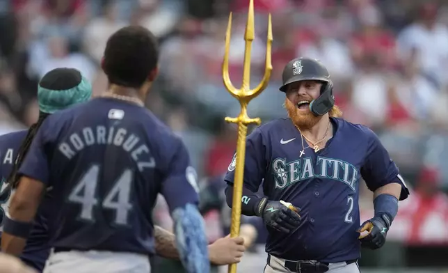 Seattle Mariners' Justin Turner (2) celebrates after hitting a home run during the second inning of a baseball game against the Los Angeles Angels in Anaheim, Calif., Saturday, Aug. 31, 2024. (AP Photo/Ashley Landis)