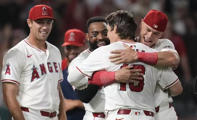 Los Angeles Angels' Mickey Moniak (16) celebrates with teammates after hitting a walk-off home run during the ninth inning of a baseball game against the Seattle Mariners in Anaheim, Calif., Saturday, Aug. 31, 2024. The Angels won 5-4. (AP Photo/Ashley Landis)