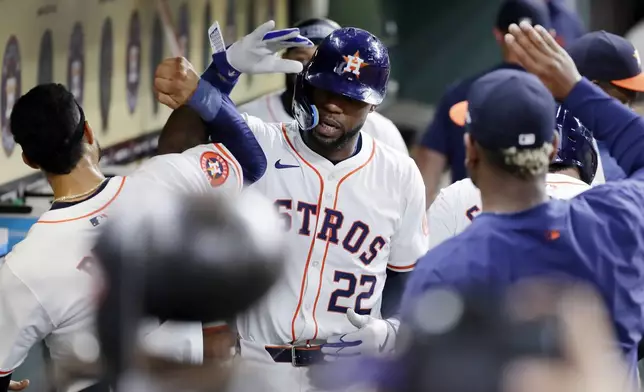 Houston Astros' Jason Heyward (22) collects high-fives in the dugout after his two-run home run against the Seattle Mariners during the fifth inning of a baseball game Tuesday, Sept. 24, 2024, in Houston. (AP Photo/Michael Wyke)