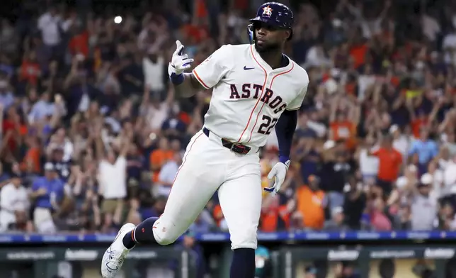 Houston Astros' Jason Heyward gestures to the dugout as he rounds the bases on his two-run home run against the Seattle Mariners during the fifth inning of a baseball game Tuesday, Sept. 24, 2024, in Houston. (AP Photo/Michael Wyke)