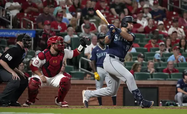 Seattle Mariners' Cal Raleigh follows through on a two-run double during the ninth inning of a baseball game against the St. Louis Cardinals Friday, Sept. 6, 2024, in St. Louis. (AP Photo/Jeff Roberson)