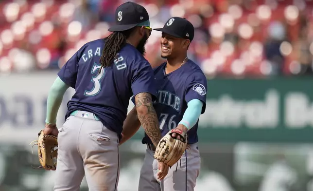 Seattle Mariners' J.P. Crawford (3) and Leo Rivas (76) celebrate a 10-4 victory over the St. Louis Cardinals following a baseball game Sunday, Sept. 8, 2024, in St. Louis. (AP Photo/Jeff Roberson)