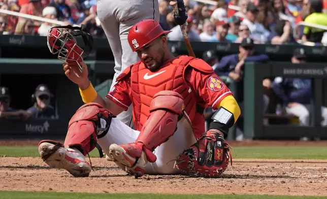 St. Louis Cardinals catcher Ivan Herrera is slow to get up after being injured during the sixth inning of a baseball game against the Seattle Mariners Sunday, Sept. 8, 2024, in St. Louis. (AP Photo/Jeff Roberson)