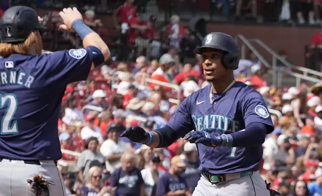 Seattle Mariners' Jorge Polanco, right, is congratulated by teammate Justin Turner (2) after hitting a two-run home run during the fifth inning of a baseball game against the St. Louis Cardinals Sunday, Sept. 8, 2024, in St. Louis. (AP Photo/Jeff Roberson)