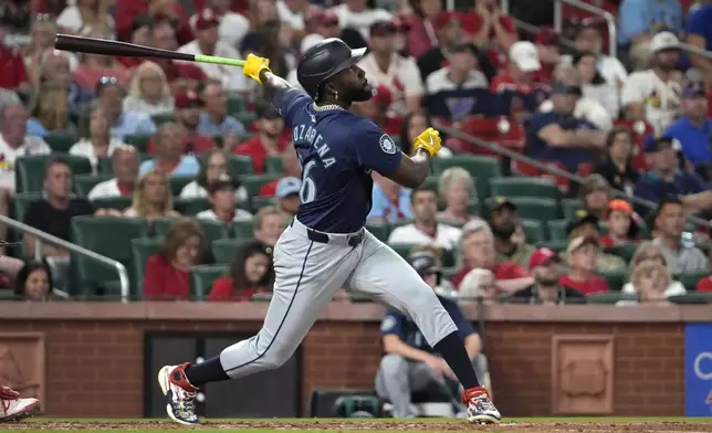 Seattle Mariners' Randy Arozarena follows through on a sacrifice fly to score Victor Robles during the fifth inning of a baseball game against the St. Louis Cardinals Friday, Sept. 6, 2024, in St. Louis. (AP Photo/Jeff Roberson)