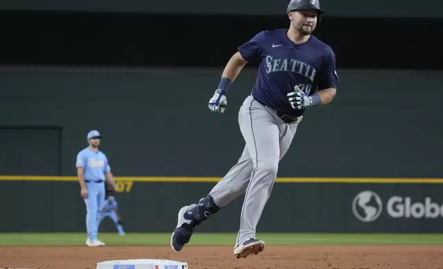 Seattle Mariners' Cal Raleigh (29) runs the bases after hitting a home run during the third inning of a baseball game against the Texas Rangers, Sunday, Sept. 22, 2024, in Arlington, Texas. (AP Photo/LM Otero)