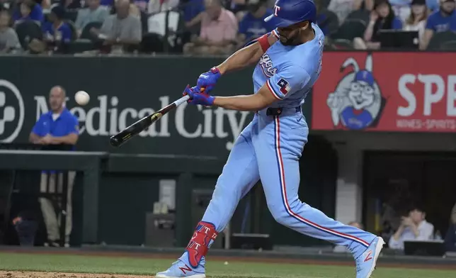 Texas Rangers' Leody Taveras hits a home run during the seventh inning of a baseball game against the Seattle Mariners, Sunday, Sept. 22, 2024, in Arlington, Texas. (AP Photo/LM Otero)