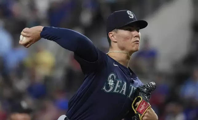 Seattle Mariners starting pitcher Bryan Woo throws during the first inning of a baseball game against the Texas Rangers, Sunday, Sept. 22, 2024, in Arlington, Texas. (AP Photo/LM Otero)