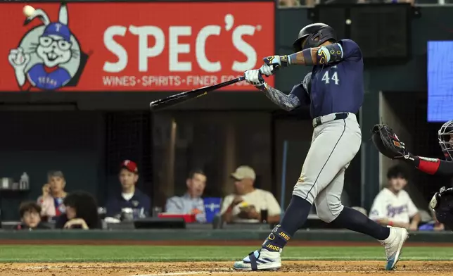 Seattle Mariners' Julio Rodriguez (44) hits a two-run home run against the Texas Rangers in the seventh inning of a baseball game Friday, Sept. 20, 2024, in Arlington, Texas. (AP Photo/Richard W. Rodriguez)