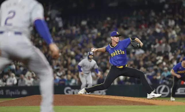 With Texas Rangers runners on the corner, Seattle Mariners starting pitcher Emerson Hancock throws to Rangers' Nathaniel Lowe in the first inning of a baseball game Friday, Sept. 13, 2024, in Seattle. (Dean Rutz/The Seattle Times via AP)