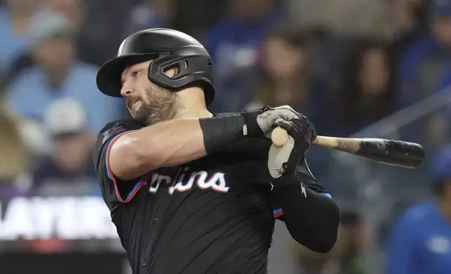 Miami Marlins' Jake Burger hits an RBI single during fourth-inning baseball game action against the Toronto Blue Jays in Toronto, Friday, Sept. 27, 2024. (Chris Young/The Canadian Press via AP)