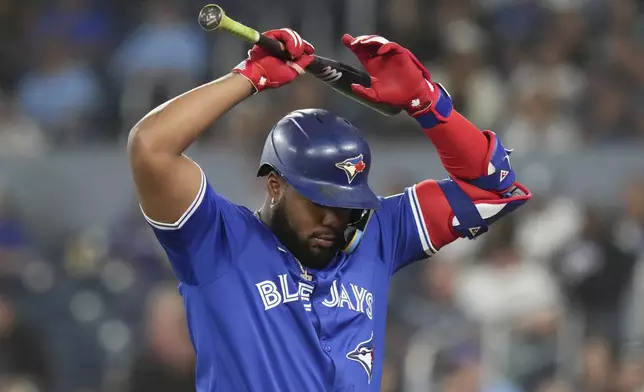 Toronto Blue Jays' Vladimir Guerrero Jr. reacts after striking out during the ninth inning of a baseball game against the Miami Marlins in Toronto, Saturday, Sept. 28, 2024. (Chris Young/The Canadian Press via AP)