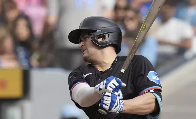 Miami Marlins' Jonah Bride hits a two-run RBI off Toronto Blue Jays pitcher Ryan Burr during first-inning baseball game action in Toronto, Sunday, Sept. 29, 2024. (Chris Young/The Canadian Press via AP)