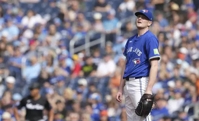 Toronto Blue Jays pitcher Ryan Burr reacts after giving up a single to Miami Marlins designated hitter Jake Burger during first-inning baseball game action in Toronto, Sunday, Sept. 29, 2024. (Chris Young/The Canadian Press via AP)