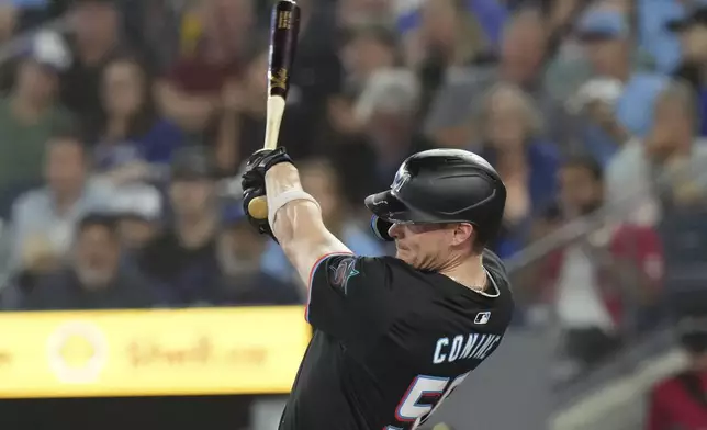 Miami Marlins' Griffin Conine hits an RBI double off Toronto Blue Jays pitcher Yariel Rodríguez during first-inning baseball game action in Toronto, Saturday, Sept. 28, 2024. (Chris Young/The Canadian Press via AP)