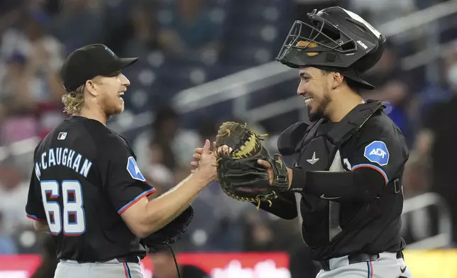 Miami Marlins pitcher Darren McCaughan celebrates with catcher Jhonny Pereda after their team's win over the Toronto Blue Jays in interleague MLB baseball action in Toronto, Saturday, September 28, 2024. (Chris Young/The Canadian Press via AP)