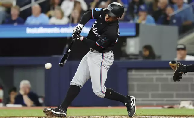 Miami Marlins' Xavier Edwards (63) hits a two-run triple against the Toronto Blue Jays during second inning interleague MLB baseball action in Toronto, Friday, Sept. 27, 2024. (Chris Young/The Canadian Press via AP)