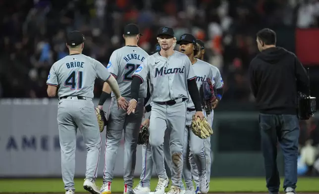 Miami Marlins left fielder Kyle Stowers, third from left, celebrates with third baseman Jonah Bride (41) after their victory over the San Francisco Giants in a baseball game Saturday, Aug. 31, 2024, in San Francisco. (AP Photo/Godofredo A. Vásquez)