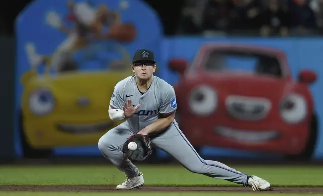 Miami Marlins third baseman Jonah Bride fields a ground ball hit by San Francisco Giants' Matt Chapman before throwing to first for an out during the eighth inning of a baseball game Saturday, Aug. 31, 2024, in San Francisco. (AP Photo/Godofredo A. Vásquez)